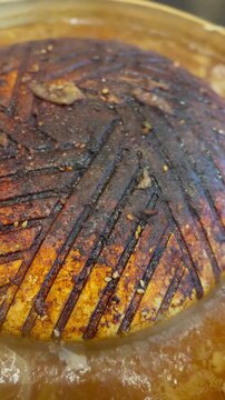 Close-up of burnt residue on grill pan surface in restaurant. Shows food safety concern and hygiene risk from overused cooking equipment and charred buildup.