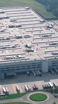 Amazon fulfillment center overview with delivery trucks and loading docks. Vertical video.