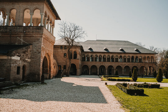 Historic courtyard with elegant arcades and traditional Romanian architecture. Peaceful cultural heritage site with symmetrical arches and historic buildings.courtyard, historic courtyard, romanian ar