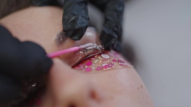 Beautician performing eyelash lamination treatment close-up
