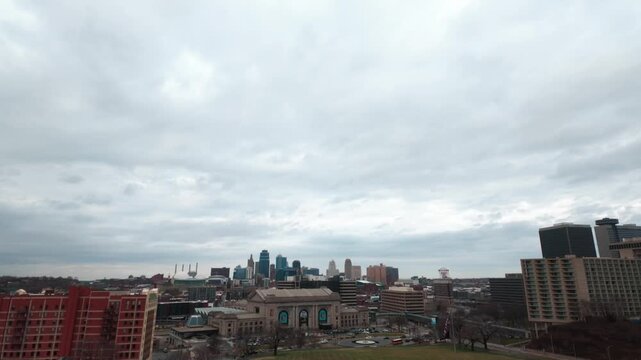 The downtown Skyline of Kansas City under a giant cloudy sky.