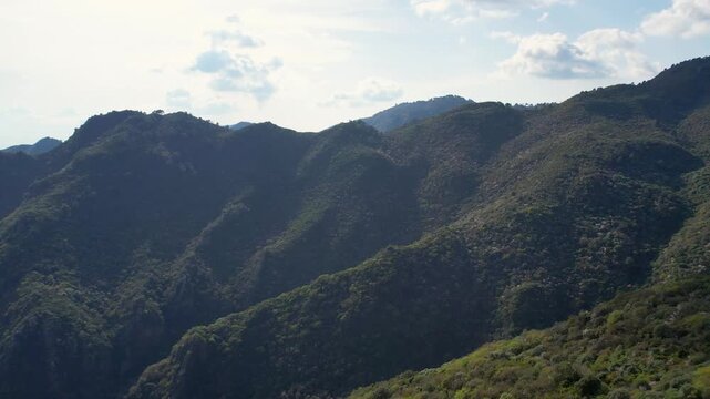 Layered green ridges of Margalla Hills under soft light with textured vegetation and distant peaks, Pakistan