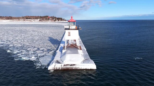 Light house in Two Harbors Minnesota during a winter cold day in Lake Superior with ice formations