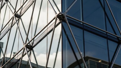 Fototapeta premium A close-up view of a modern glass building with a geometric framework