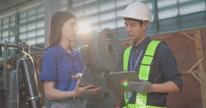 Entrepreneur explains custom DIY workpiece requirements to an engineer, reviewing parts, design options and prototype specifications in a workshop during development planning.
