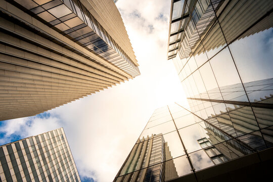 Converging perspective with sunlight on skyscraper architecture in Paris La Defense capturing corporate office finance business drive and urban scale