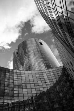 Monochrome view of glass skyscraper architecture in Paris La Defense capturing corporate office finance business atmosphere around a modern tower