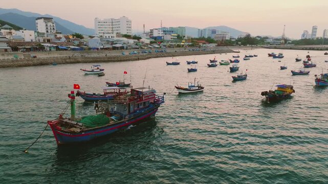 Aerial of traditional Vietnamese fishing boats with red flags at sunset, Nha Trang
traditional wooden fishing boats anchored in the Lang Chut area of Nha Trang, Vietnam