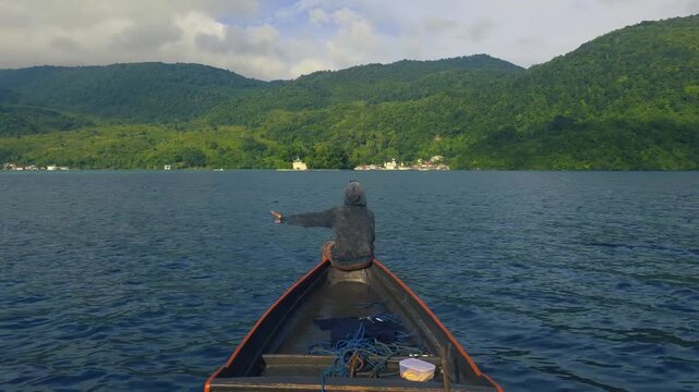 POV Traditional Wooden Boat Sailing Toward Coastal Village in Kei Islands Indonesia
