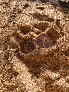UAE Dirham Coins Partially Buried in Desert Sand