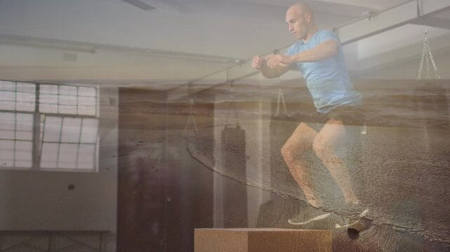 Animation of seascape over fit caucasian man training at gym