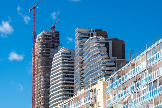 Modern Benidorm Spain skyline with blue sky highrise towers and crane during construction capturing growth of a dense coastal city today