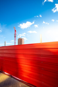 Red barrier and street construction in Benidorm Spain captured in daylight with motion streaks conveying urban development speed and change