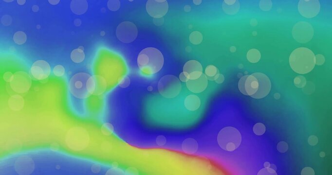 Animation of white light orbs over green and pink blots