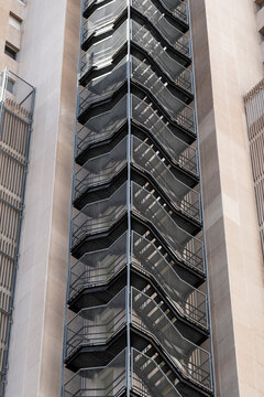 Vertical architecture exterior metal staircase structure with symmetry geometry pattern in urban abstract texture background design