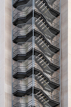 Industrial architecture exterior metal staircase structure detail with symmetry geometry pattern for urban abstract texture background