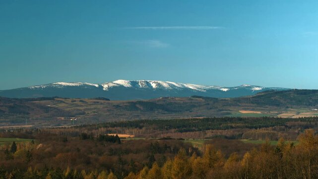 View of Western Karkonosze from Polish side, snow, blue sky with clouds, zoom shot