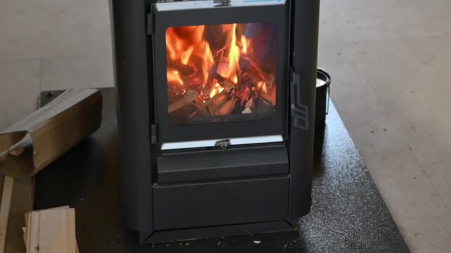 Cozy small fireplace with a burning fire in a home interior