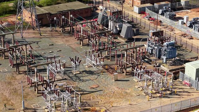 Detailed close up aerial view of electrical substation, with busbars, high voltage pylons and transformers in Coalville UK