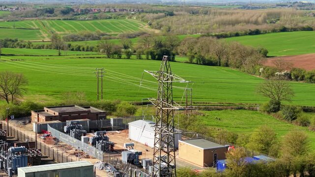 Detailed close up aerial view of electrical substation, with busbars, high voltage pylons and transformers in Coalville UK