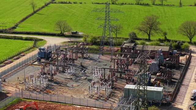 Detailed close up aerial view of electrical substation, with busbars, high voltage pylons and transformers in Coalville UK