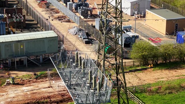 Detailed close up aerial view of electrical substation, with busbars, high voltage pylons and transformers in Coalville UK
