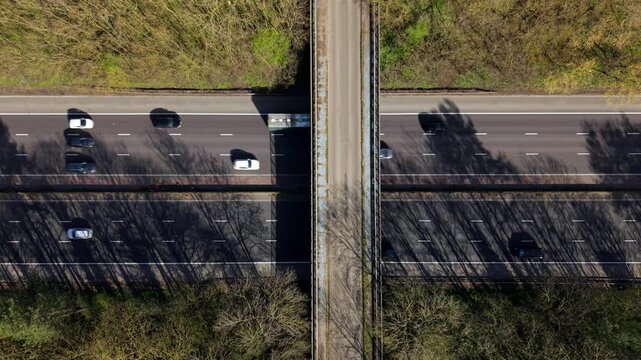 Top down aerial reveal of busy traffic driving on the M1 motorway, UK