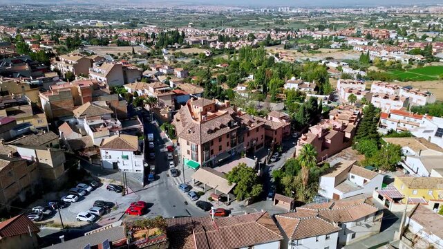 Aerial drone view of Monachil neighborhood near Granada with Sierra Nevada mountains, Spain