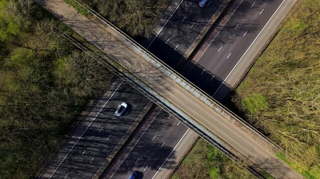 Aerial drone view of heavy traffic flowing on the M1 motorway and a bridge crossing in the UK