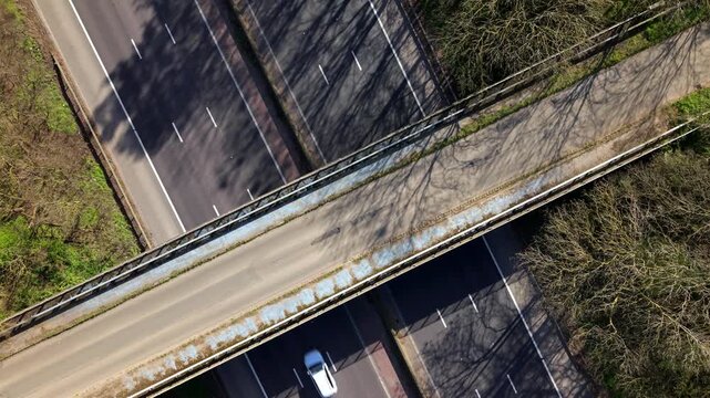 Aerial drone view of heavy traffic flowing on the M1 motorway and a bridge crossing in the UK