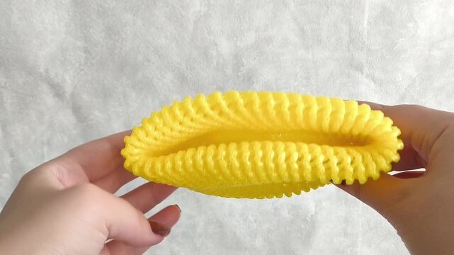 Hands pull foam mesh for fruit packaging. Packaging for transportation, delivery of fresh vegetables