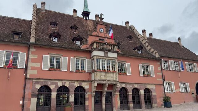 Town hall (Hotel de Ville) of Barr city. French and European Union flags are waving. Old historical building. Alsatian towns. Barr, Alsace, France