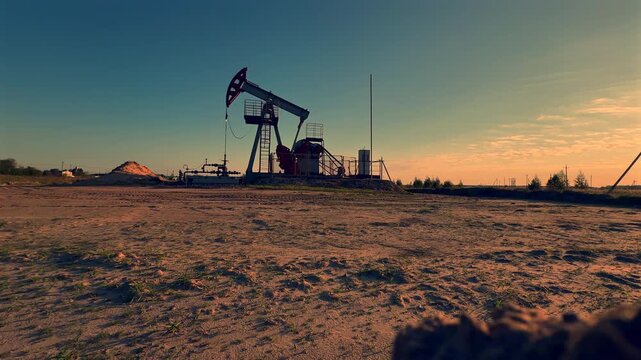 Extraction of petroleum. Oil Pump Jack on blue. Oil Field. Petrolium crude Industrial. Crude pump jack working.. Extraction of petroleum in oilfield. Crude petroleum industry