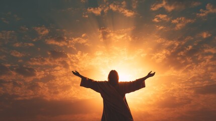 Fototapeta premium Jesus Christ stands with arms outstretched towards golden sunset sky