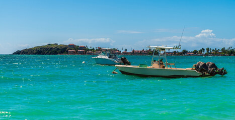 A view past boats moored off the Great Bay Beach in Philipsburg, Sint Maarten on a sunny day