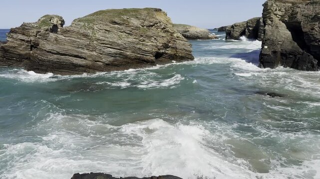 sea water during the surf, waves crashing against coastal rocks, Lanzada beach, O Grove, Galicia, Spain, slow motion