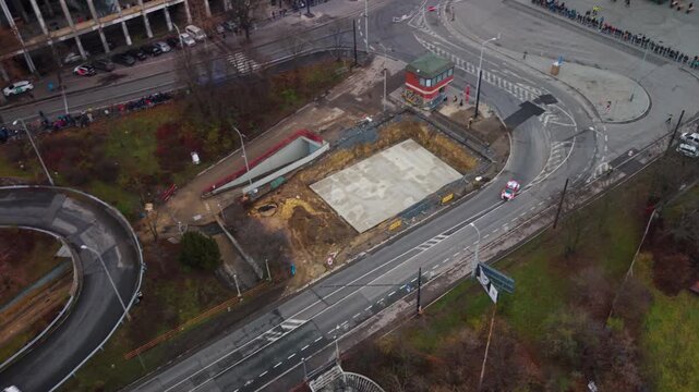 Aerial view of rally car racing through sharp hairpin turn near Strahov Stadium in Prague during autumn