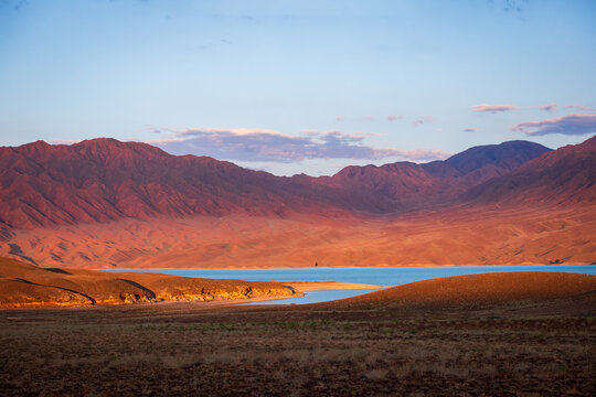 Nature park of Kazakhstan near Almaty, central Asia. Amazingly picturesque morning landscape of Tien Shan red mountains and Lake Bartogai.