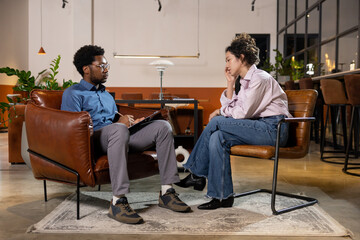 Man looking at sad woman client during session