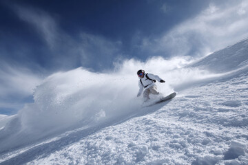 Snowboarder carving fresh powder on mountain slope