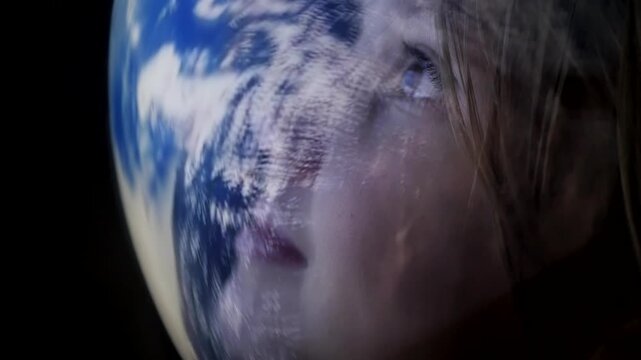 Cute child in astronaut helmet watching with wonder and admiration a planet from space Girl in spacesuit looking through glass at view of space and Earth. Discovery of new horizons. Flight to the Moon