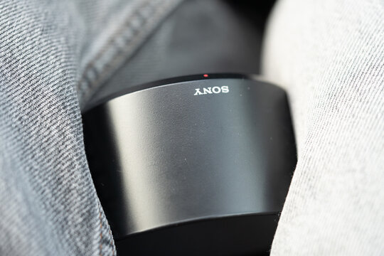 Moscow, Russia - April 6, 2026:Extreme close-up of a Sony lens hood resting on someone&rsquo;s lap. Visible "Sony" branding. Photography gear detail, texture, and product focus.