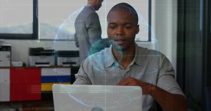 Seated man typing on laptop, activating holographic globe over screen while analyzing business data