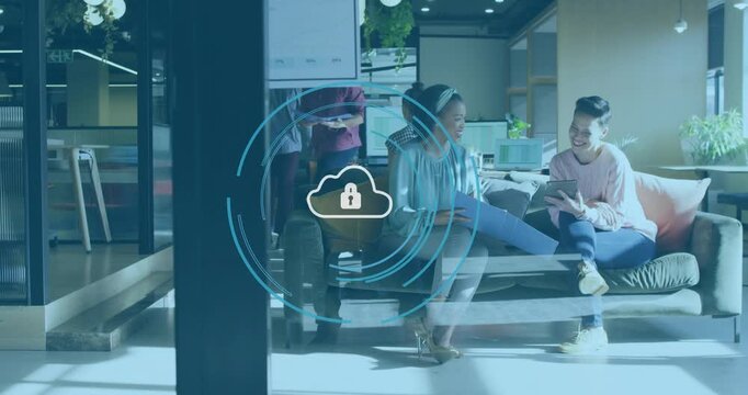 Two women sharing tablet in lounge one tapping pulsing cloudlock overlay linking to cloud security