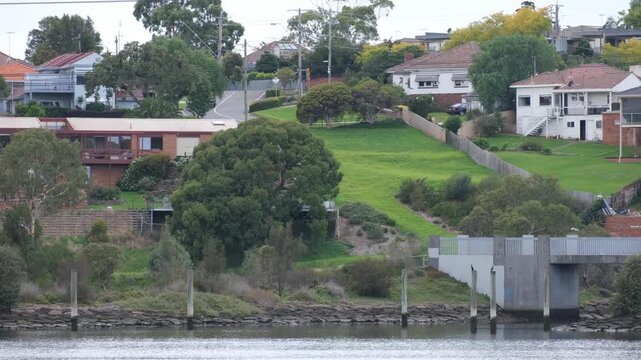 Residential waterfront neighbourhood in Ascot Vale, Melbourne, Australia, featuring detached houses, and varied terrain along Maribynong River. Suburban established homes, livable environment.