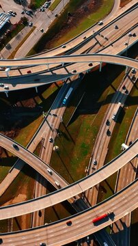 Cars move by the roads and freeways in Dallas, Texas, USA. Top view of the highways on sunny daytime.
