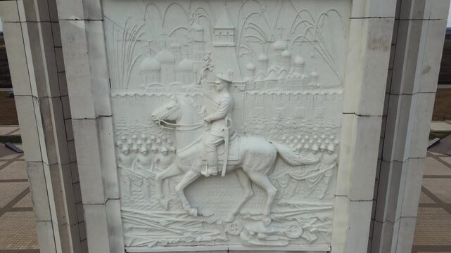 Kursk battle memorial obelisk in Prokorovka field, Belgorod oblast of Russia, with images of warriors and historic figures (by V. Klykov, 1995).
