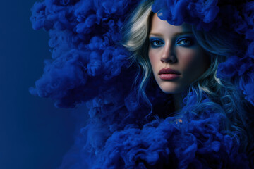 Fototapeta premium Dramatic portrait of fierce woman in deep blue fur hood with intense expression