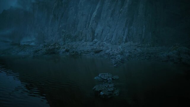 tidal pool beneath towering mist cliff, dark teal water with small rocky islets and glassy surface gentle ripples mirror steep basalt face, subtle algae
