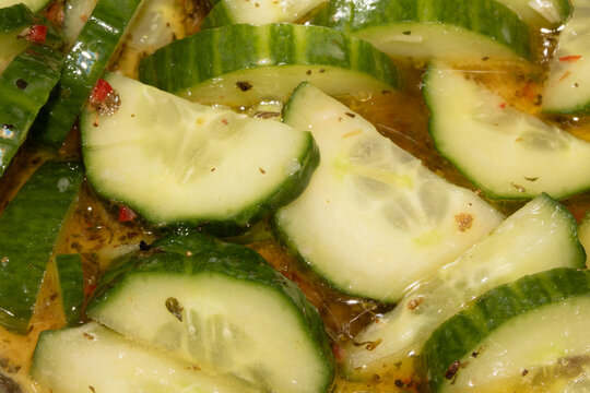 Close up spicy chopped sliced cucumber in olive oil salad and chili
